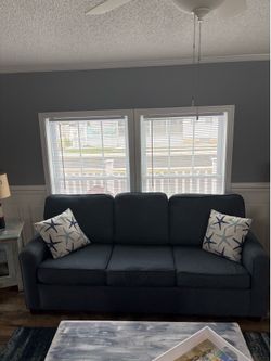 Blue sleeper sofa.  No pets. No tears. Slept on once.