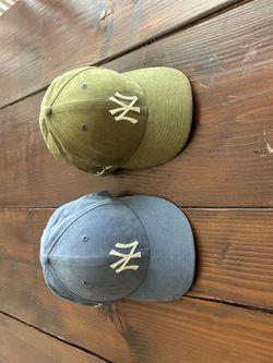 Ladies Yankees hats size 7 3/8.
