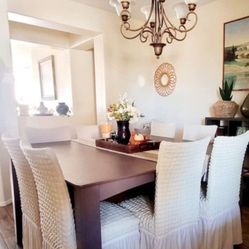 Large wood dining room table with 6 chairs.
