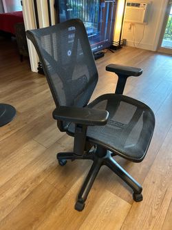 Black adjustable office chair with rollers