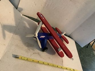 vintage "Dragon Fly" wooden model airplane, styled like a U.S. Navy https://offerup.com/redirect/?o=YmlwbGFuZS5JdA== features a bright blue fuselage, 