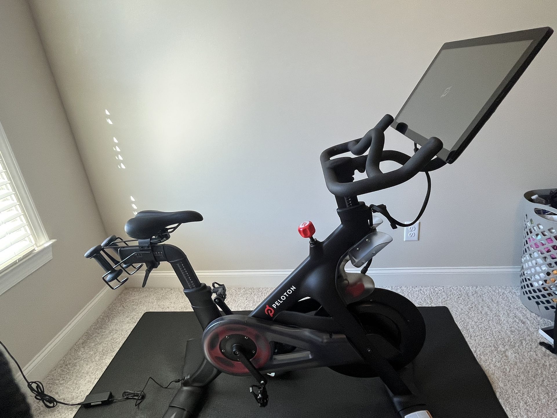 Peloton bike, mat, and shoes