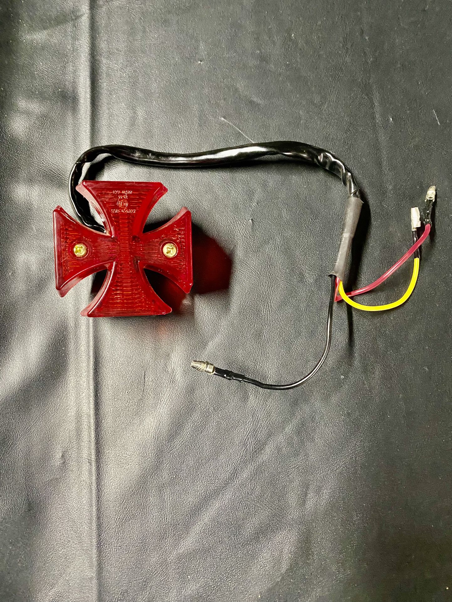 Red cross-shaped tail Light