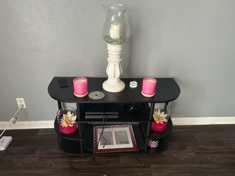 Tv stand , with pink candles
