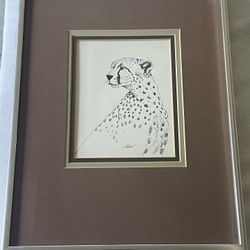 Framed pencil sketch print of a cheetah, signed by the artist. 14.25”x 11.25” Including Frame