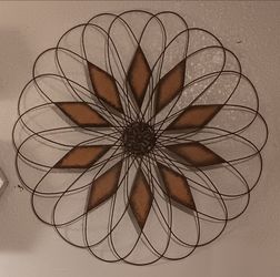 Large metal decorative wall piece with brown accents 35" in diameter.