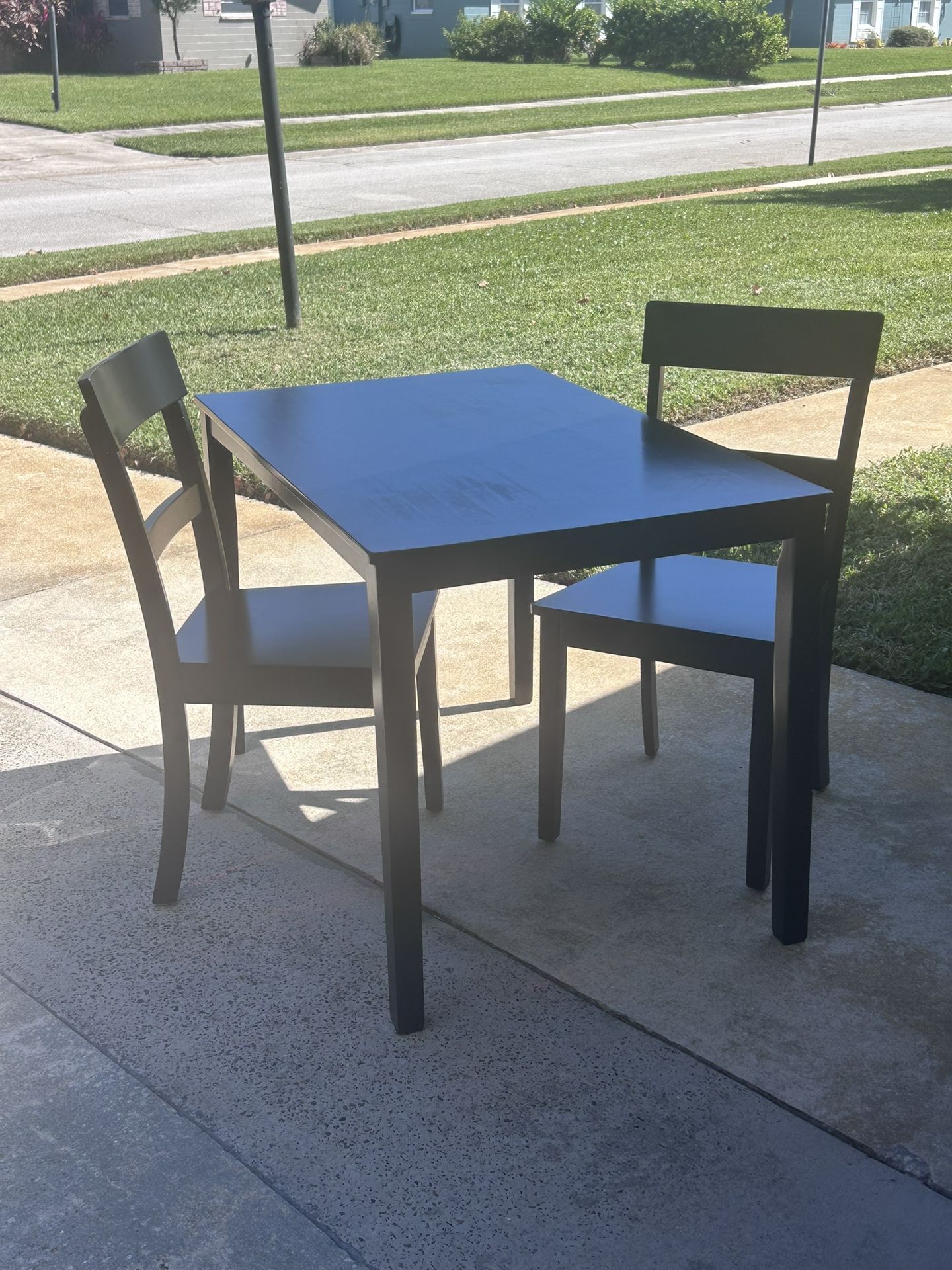 Black Wooden Table with Two Chairs