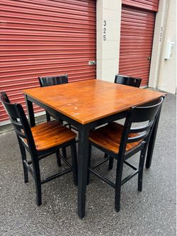 Square wooden high table and four chairs