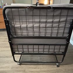 Foldable bed with mattress  on casters