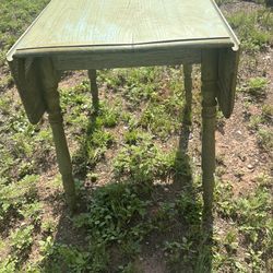 old wood table with sides that fold out . Its 29 onche tall 34 inches wide and 23 with sides in