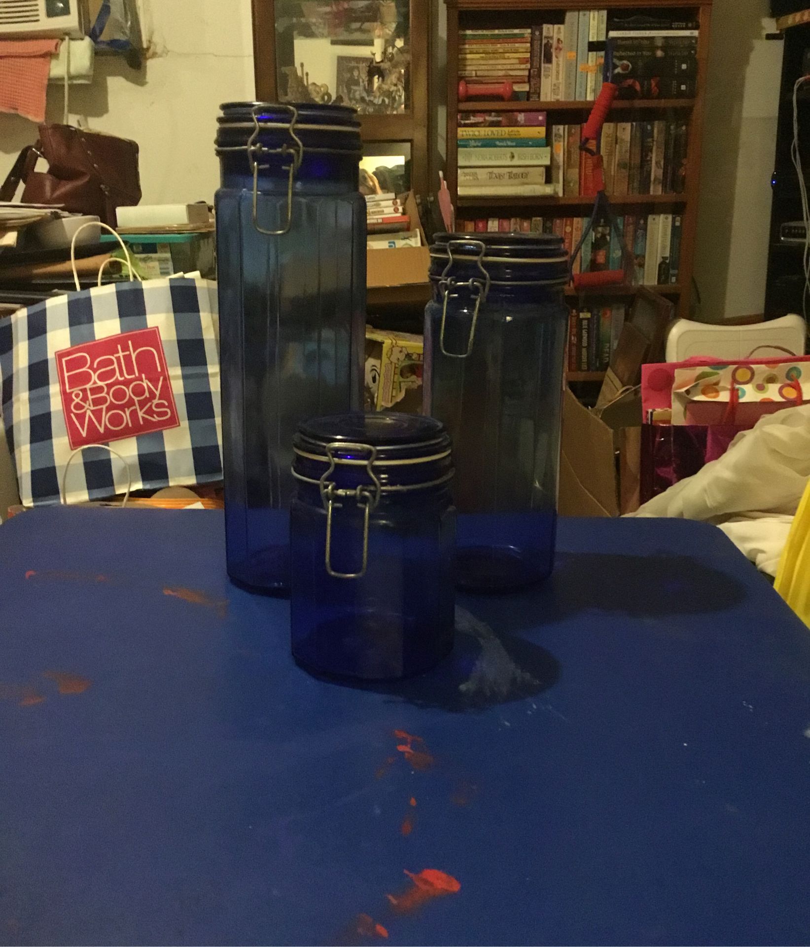 Set of three blue glass canisters with metal lids