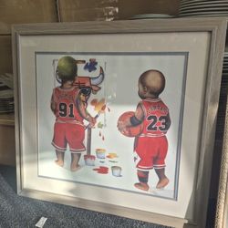 framed print of "Bulls In The Paint" by artist Kenneth Gatewood, depicting Michael Jordan (#23) and Dennis Rodman (#91) as toddlers. 