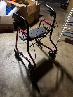 Red rollator walker with seat