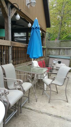 Table and 4 chairs and umbrella