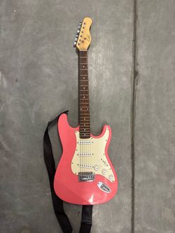 Pink Stratocaster-Style Electric Guitar with Strap