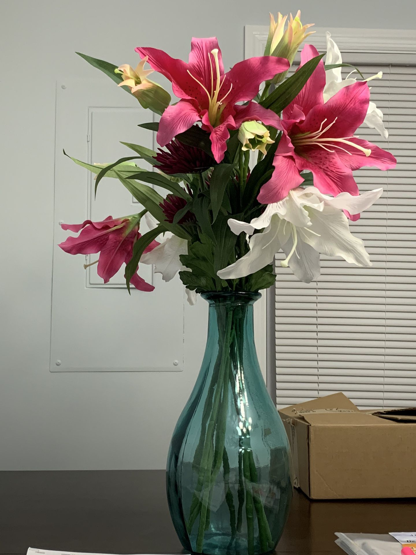 Glass vase with silk floral arrangement.
