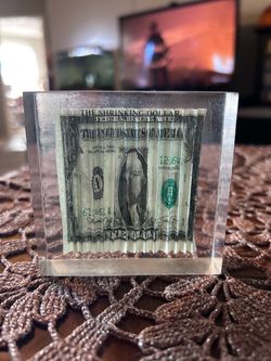 The Shrinking Dollar Acrylic Novelty Paperweight