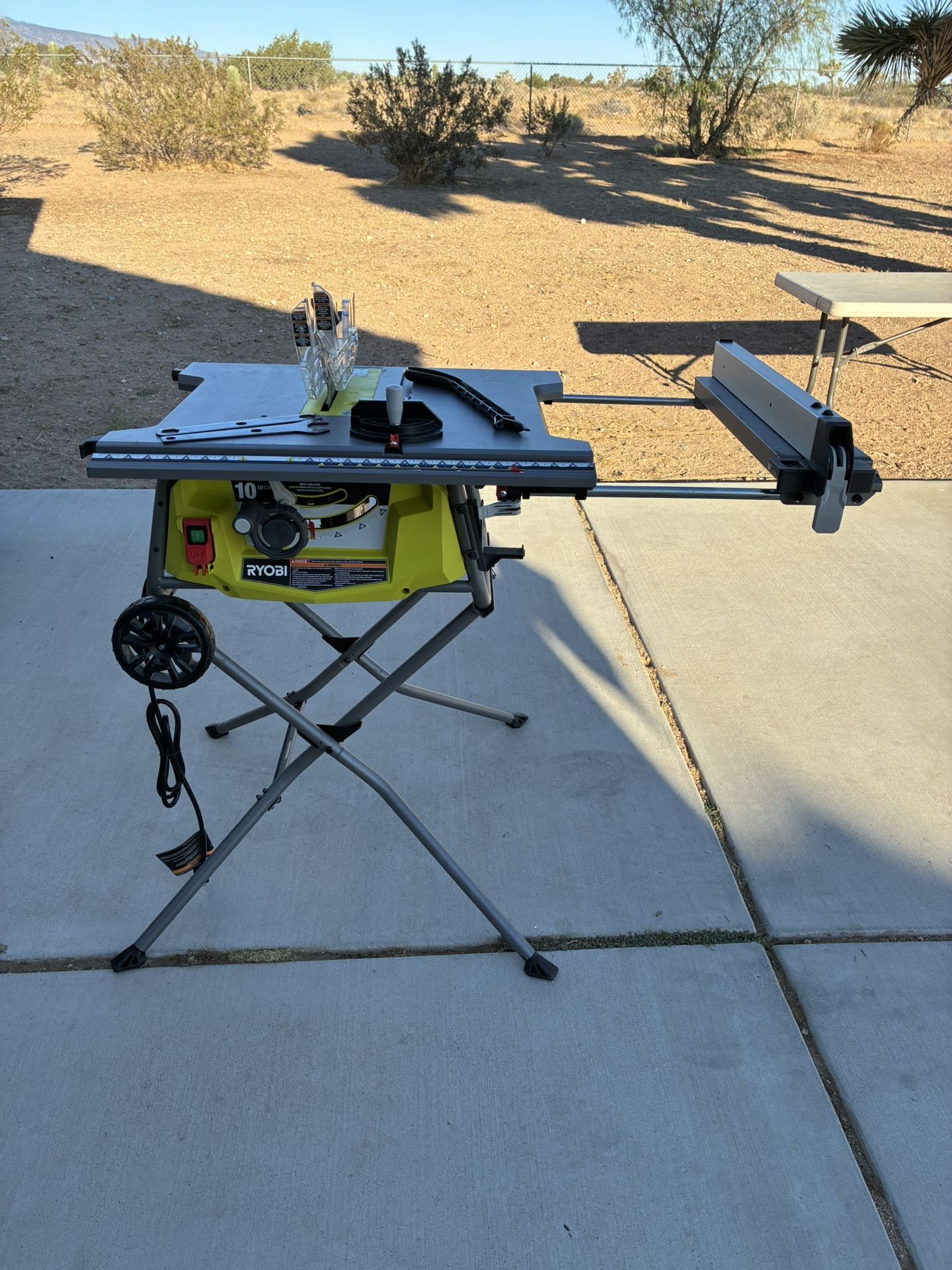 RYOBI 10 in. Corded Table Saw Extends And W/ Rolling Stand