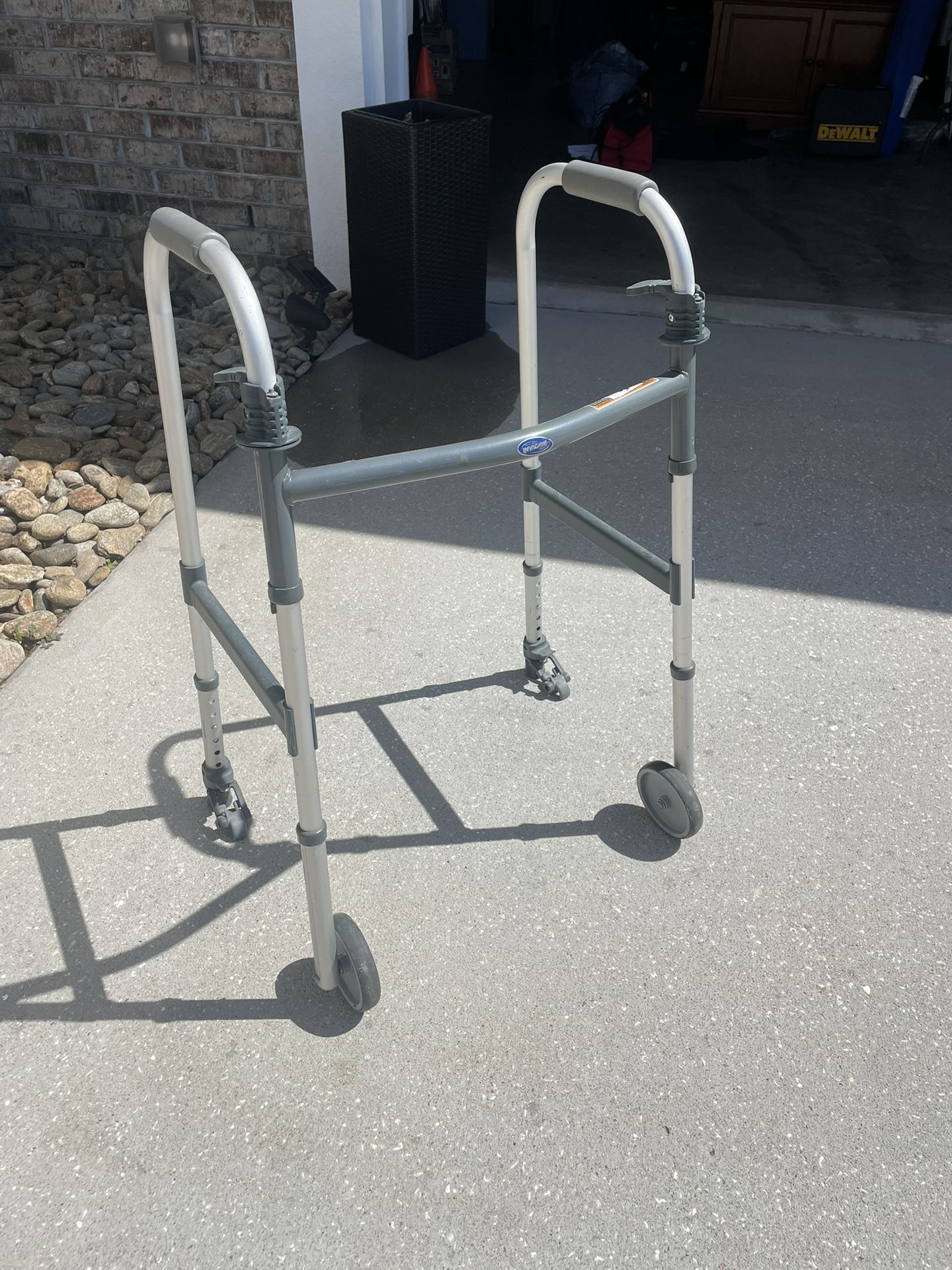 Invacare Adult Walker. with wheels. foldable. padded handles