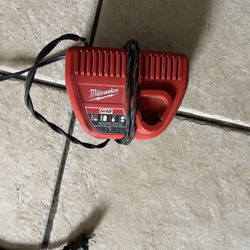 This is a Milwaukee M12 Lithium-Ion battery charger (model 48-59-2401). 