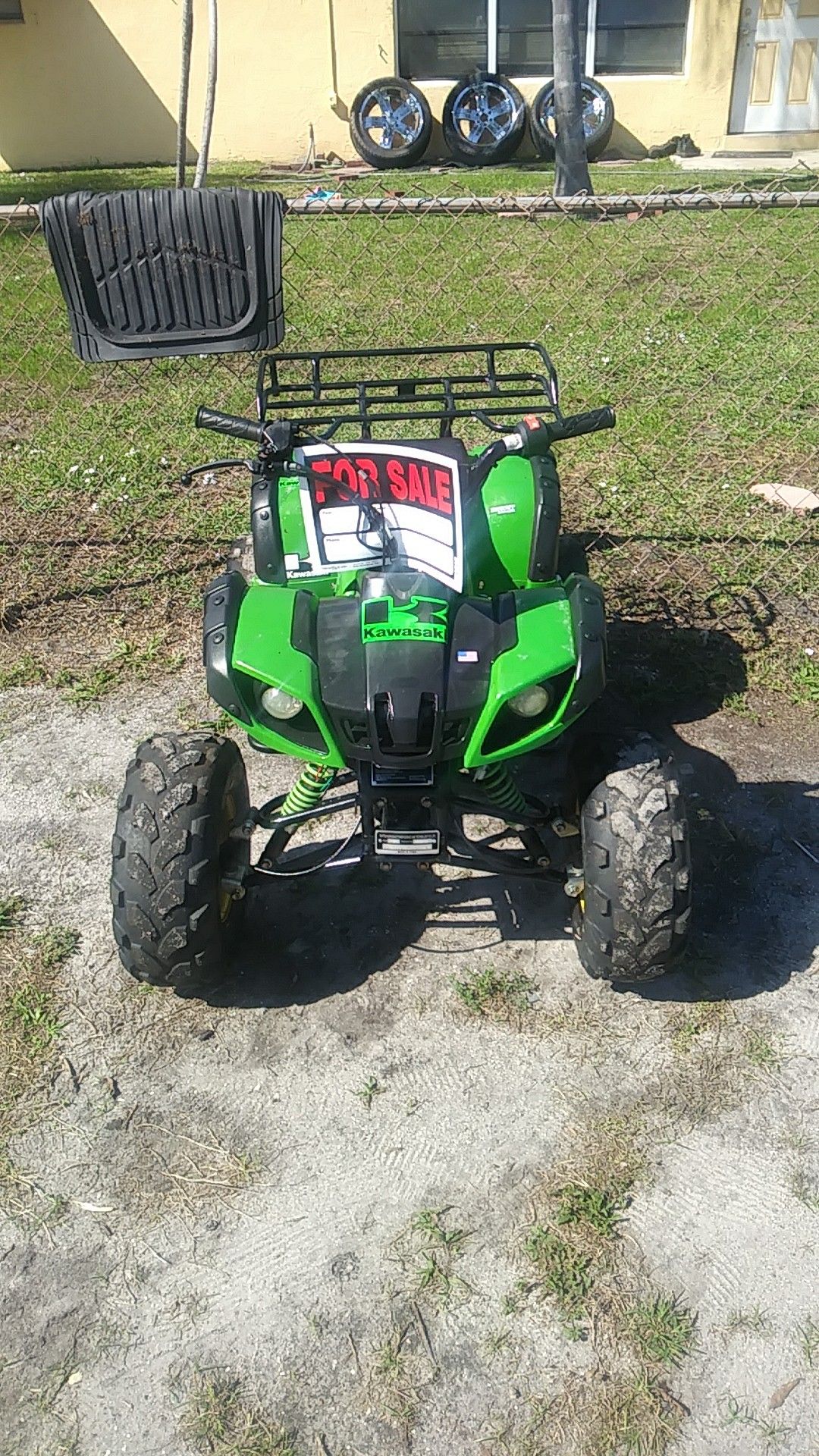 A kid Kawasaki 125 4-wheeler has reverse