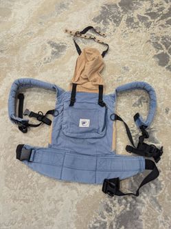Blue Denim Ergobaby Carrier with Beige adjustable Hood and a convenient front Pocket