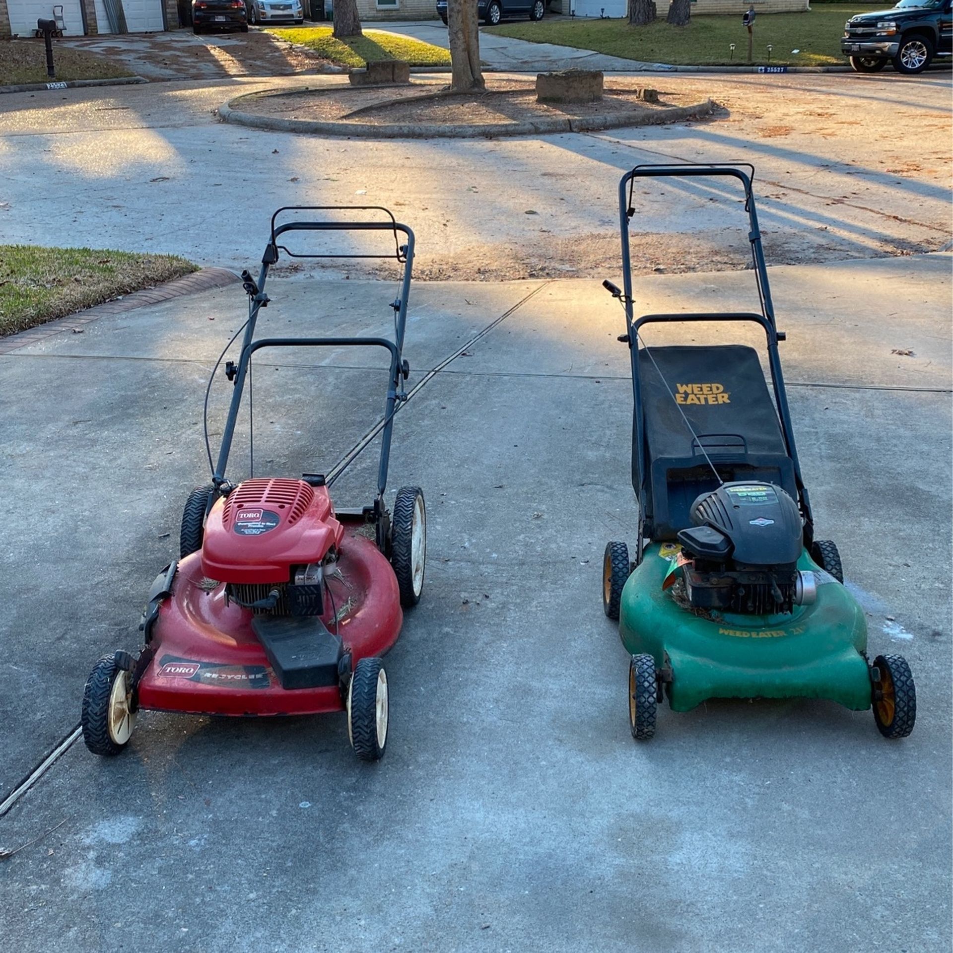 Two Running Lawn Mowers