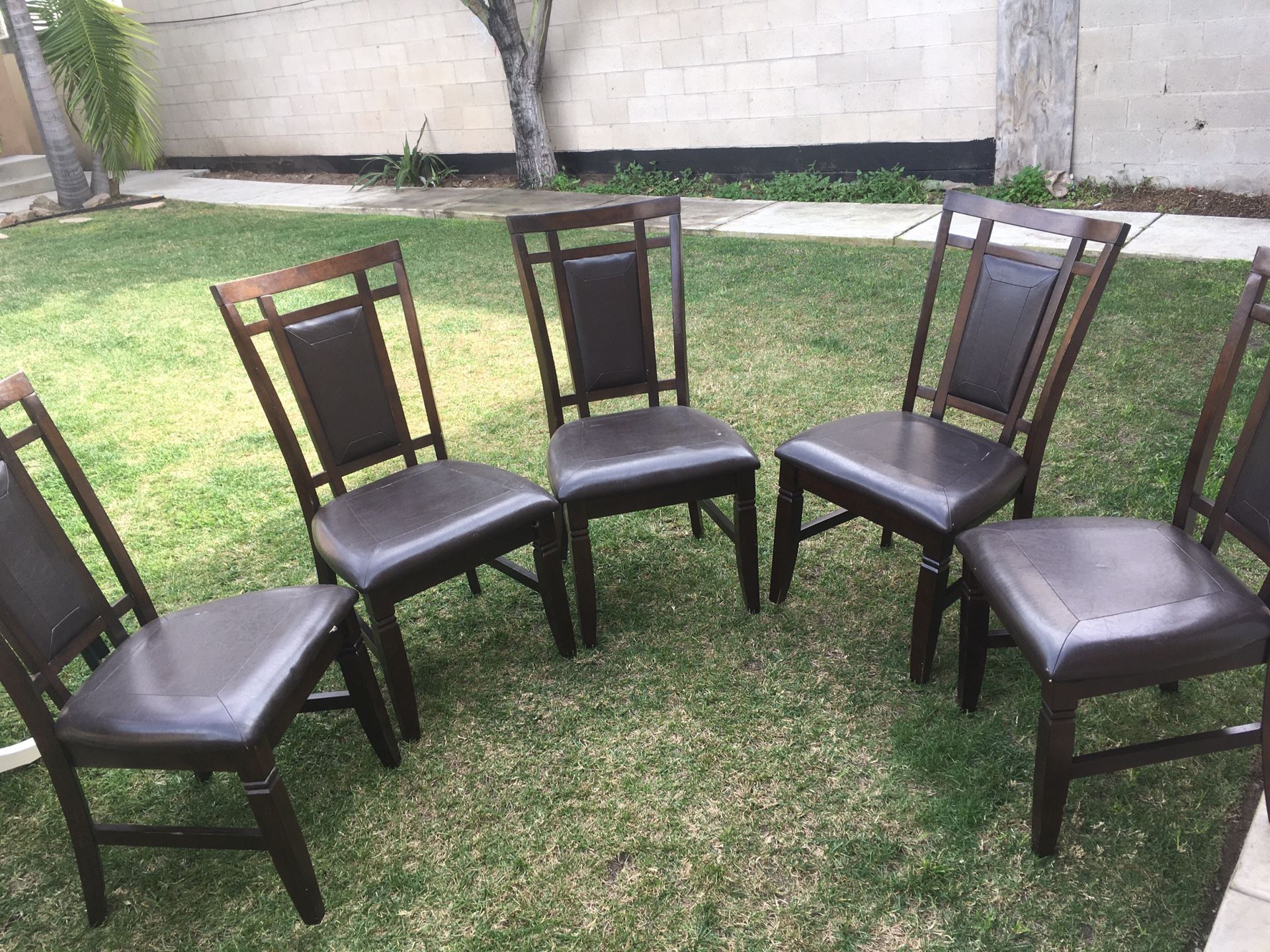 5 wood padded chairs