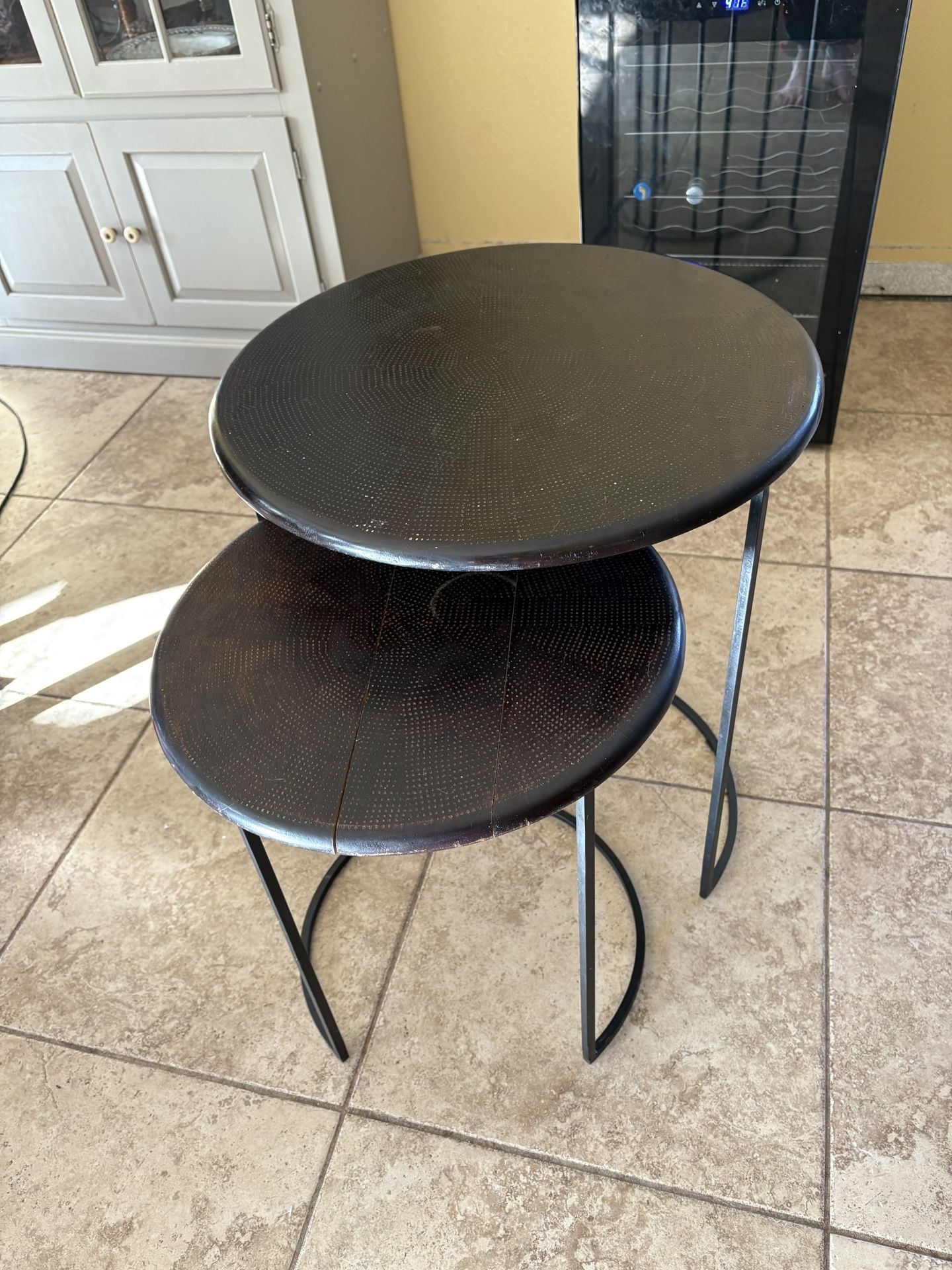 small wooden black tables with metal stands attached