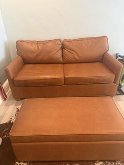 Brown leather sofa and ottoman