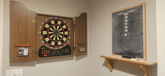Arachnid Electronic Dartboard Cabinet Set with chalk scoreboard and game room sign
