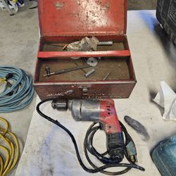 Milwaukee half inch Drill motor with box.