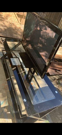 Tv. Tv glass stand and lawn mower.
