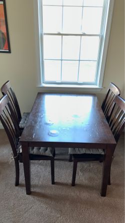Wooden dining table with 4 chairs.