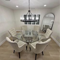 round glass dining table with a chrome/metal base