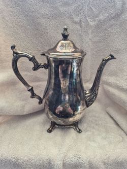 resembles a vintage silver-plated teapot or coffee pot from brands like Wm A Rogers or FB Rogers. Silver