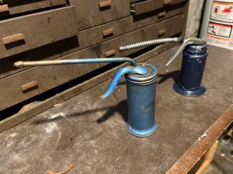 Blue vintage oil pump cans