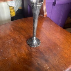 This is a vintage silver-plated trumpet vase.