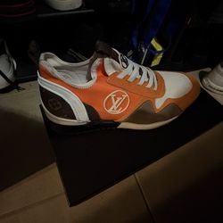 Louis Vuitton Run Away sneakers in an orange and brown colorway with Monogram canvas detailing. 