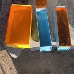 Three Plastic Containers With The Lids That Open