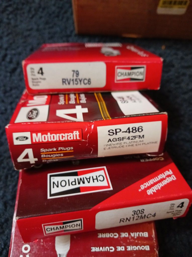 Four Sets Of Spark Plugs Three Champions One Motorcraft