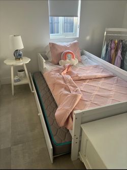 Twin white bed with trundle and mattress