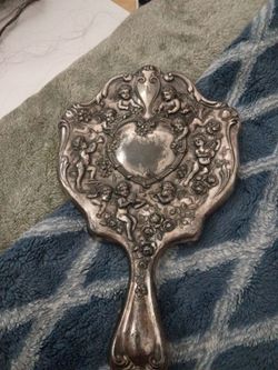 Antique cherub hand mirror