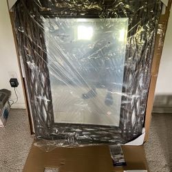 Wall mirror with vine-like metal frame