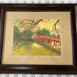 Hand-embroidered silk threads on fabric of autumn scenery Huc Bridge in Hanoi, Vietnam