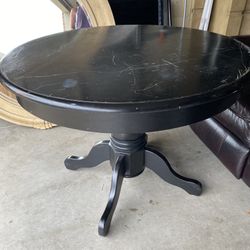 solid wood round pedestal dining table in a black finish-perfect to refinish 