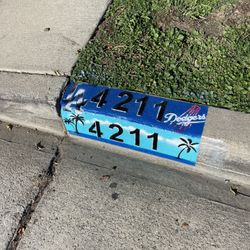Dodgers Curb Address With Beach Scene Background