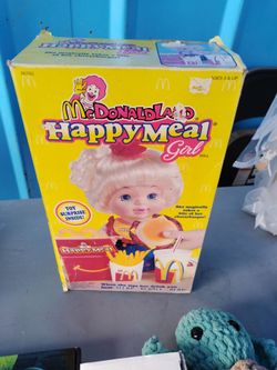 This vintage 1997 Hasbro McDonaldland Happy Meal Girl doll comes in its original yellow box.The doll features a mechanism that allows it to "magically