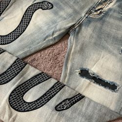 AMIRI jeans with snakes and snake print