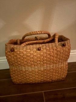 handwoven straw or water hyacinth double-handle tote bag featuring a textured weave pattern